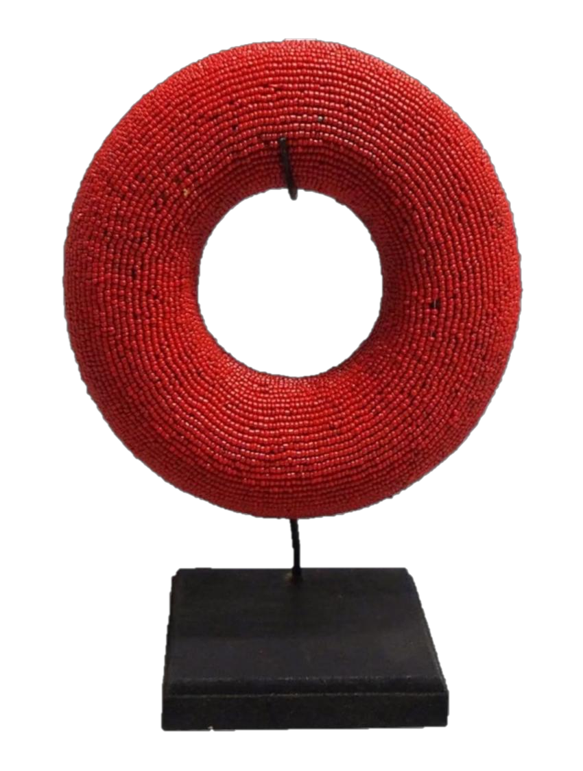 Red beaded Tikar bangle displayed on a stand, handcrafted from thousands of tiny glass beads